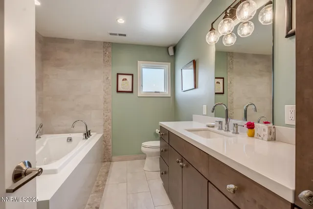 a bathroom with a tub and sink
