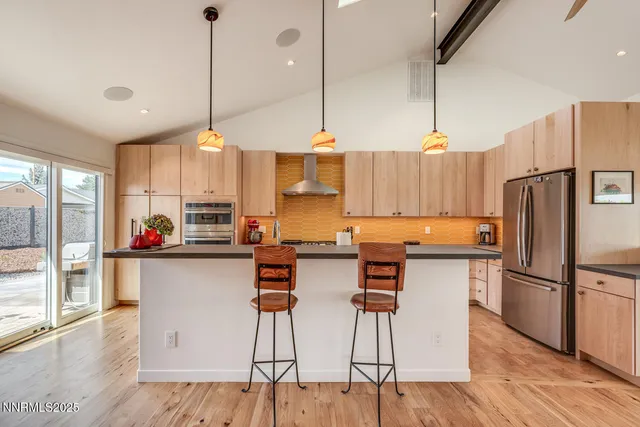 a kitchen with a sink a counter top stainless steel appliances and cabinets