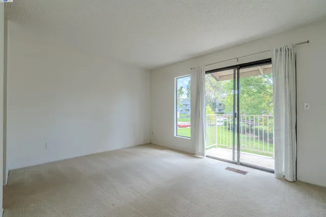 a view of empty room with floor to ceiling window