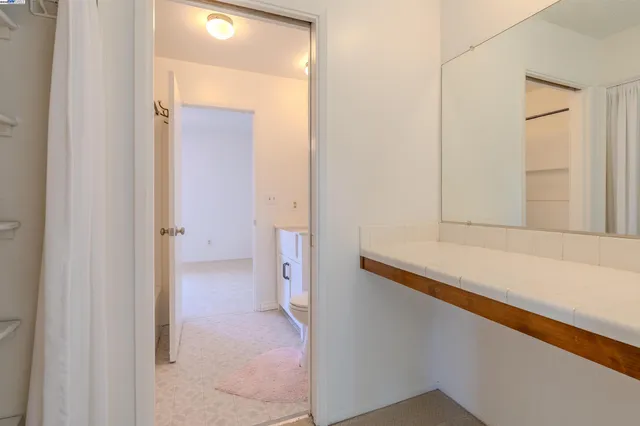 a view of bathroom with mirror