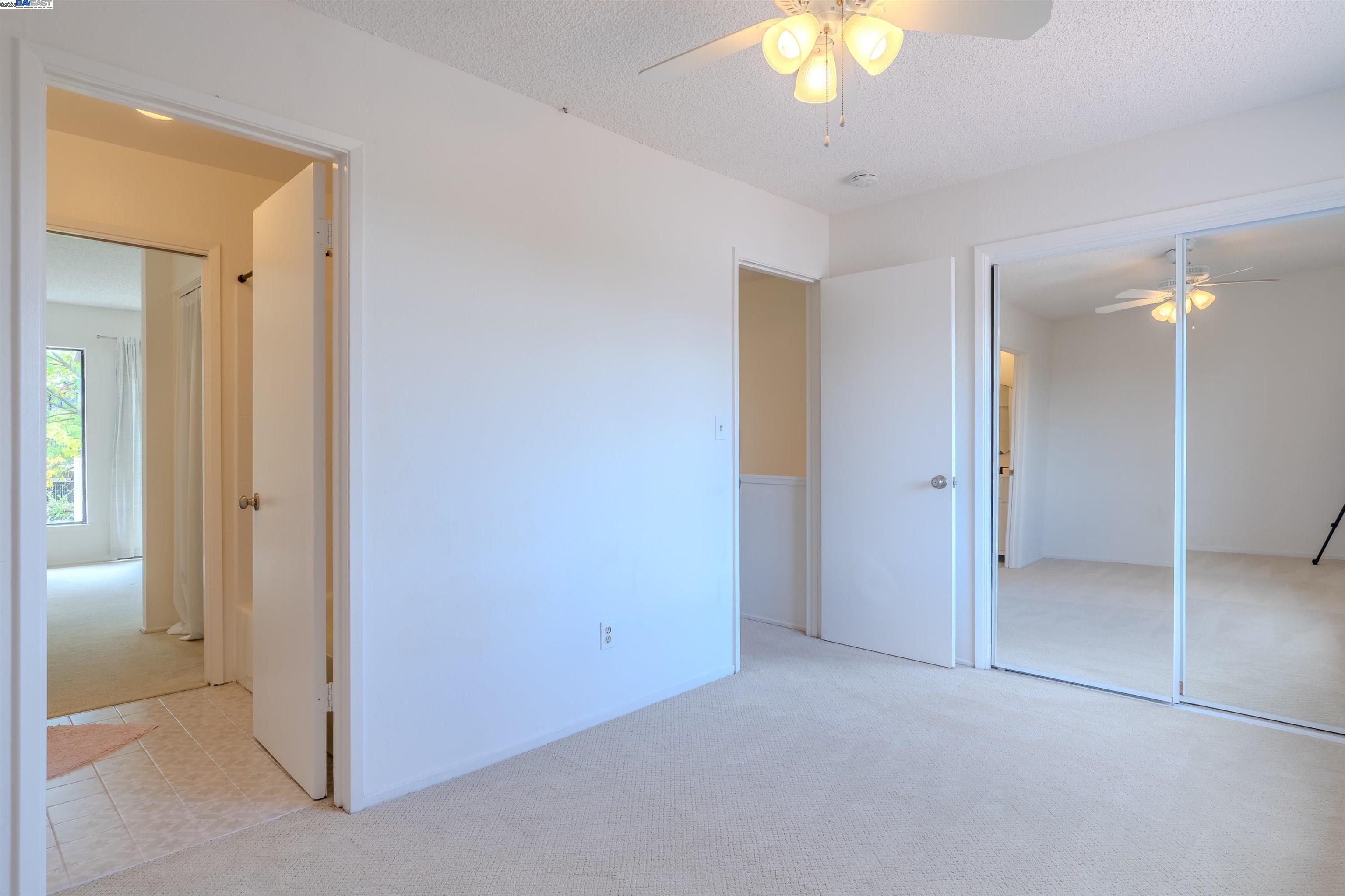 1785 Paseo Laguna Seco Livermore, CA 94551 - Photo 23 of 27 an empty room with a bathroom and a chandelier fan