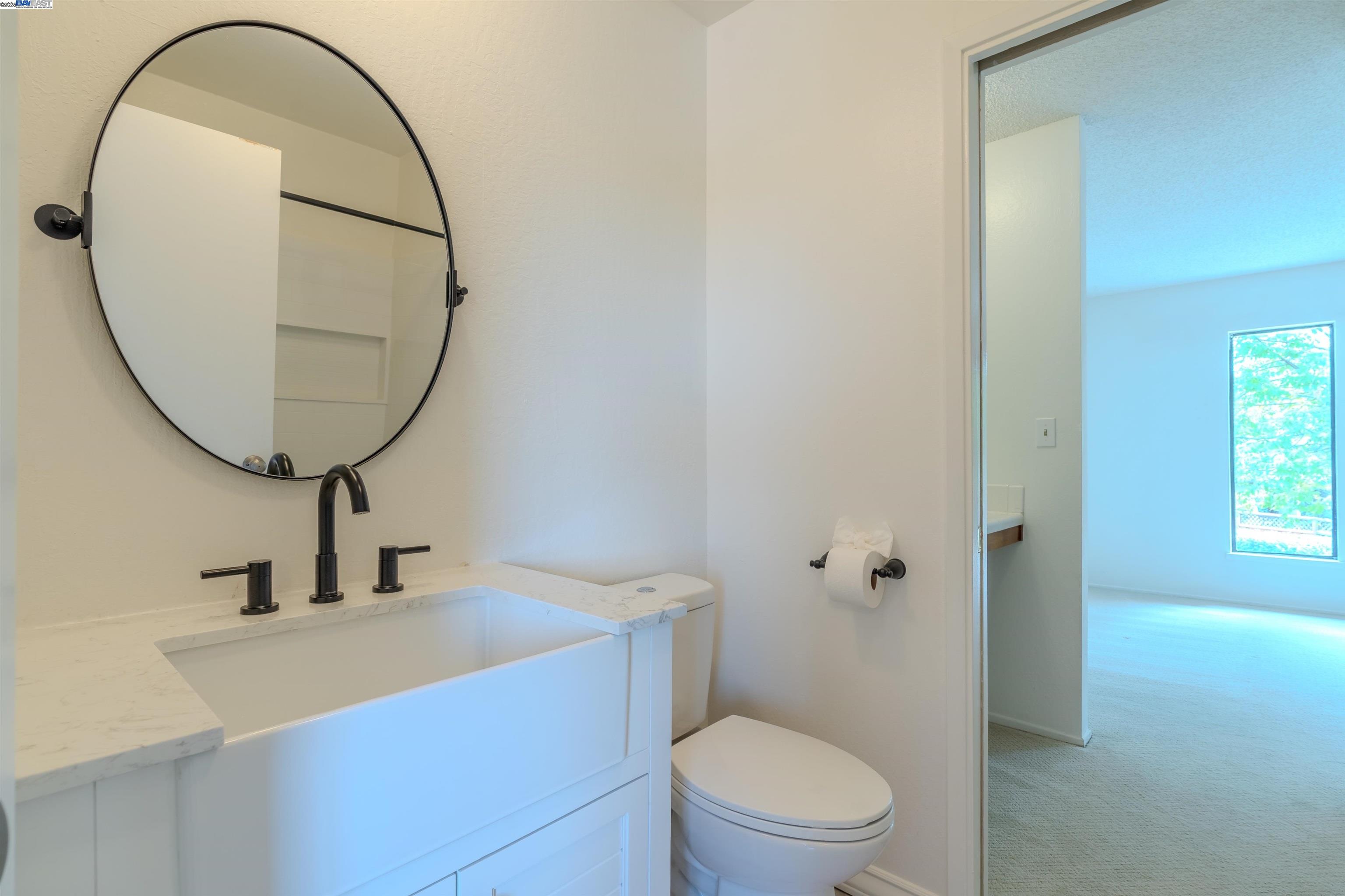 1785 Paseo Laguna Seco Livermore, CA 94551 - Photo 25 of 27 a bathroom with a sink a toilet and a mirror