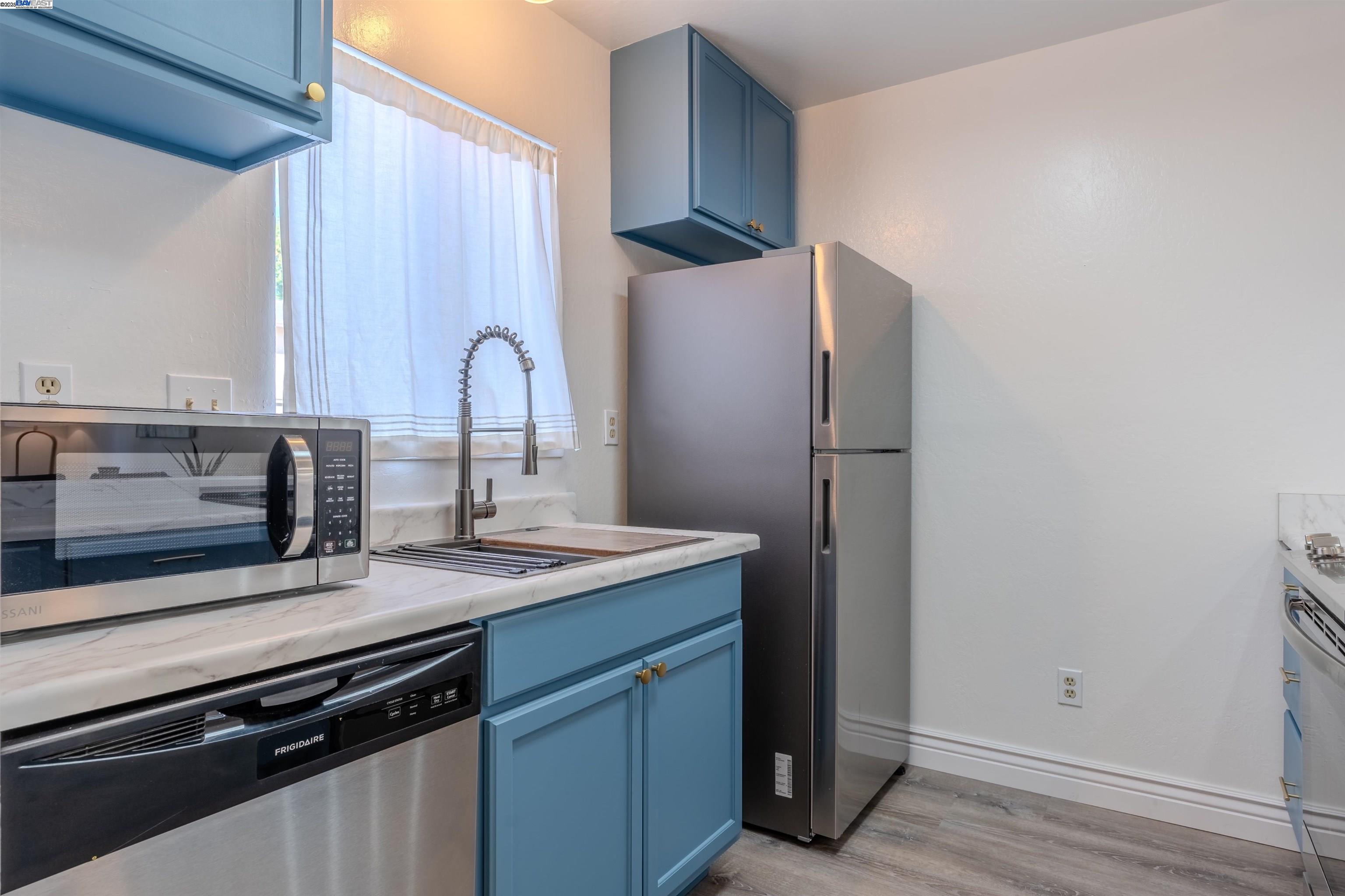 1785 Paseo Laguna Seco Livermore, CA 94551 - Photo 6 of 27 a kitchen with a sink and a refrigerator