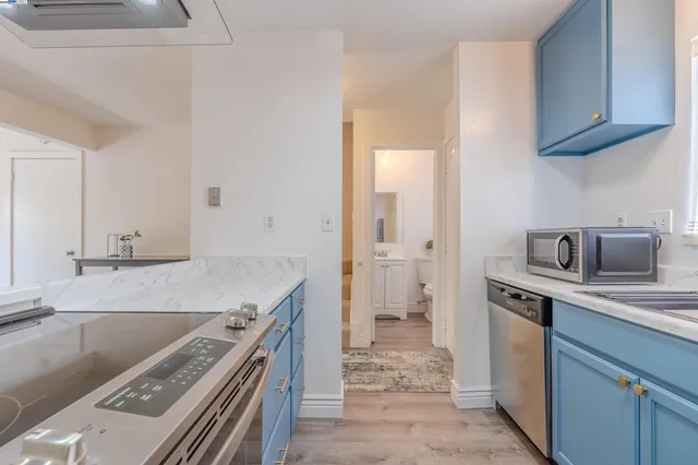 a kitchen with a stove sink and refrigerator