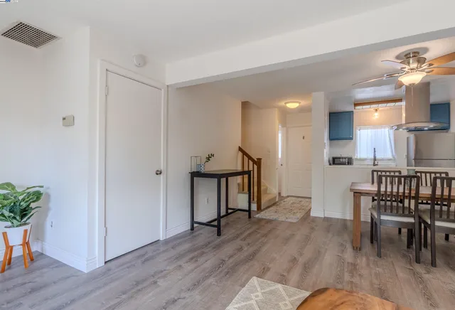 a view of a livingroom with furniture and hardwood floor