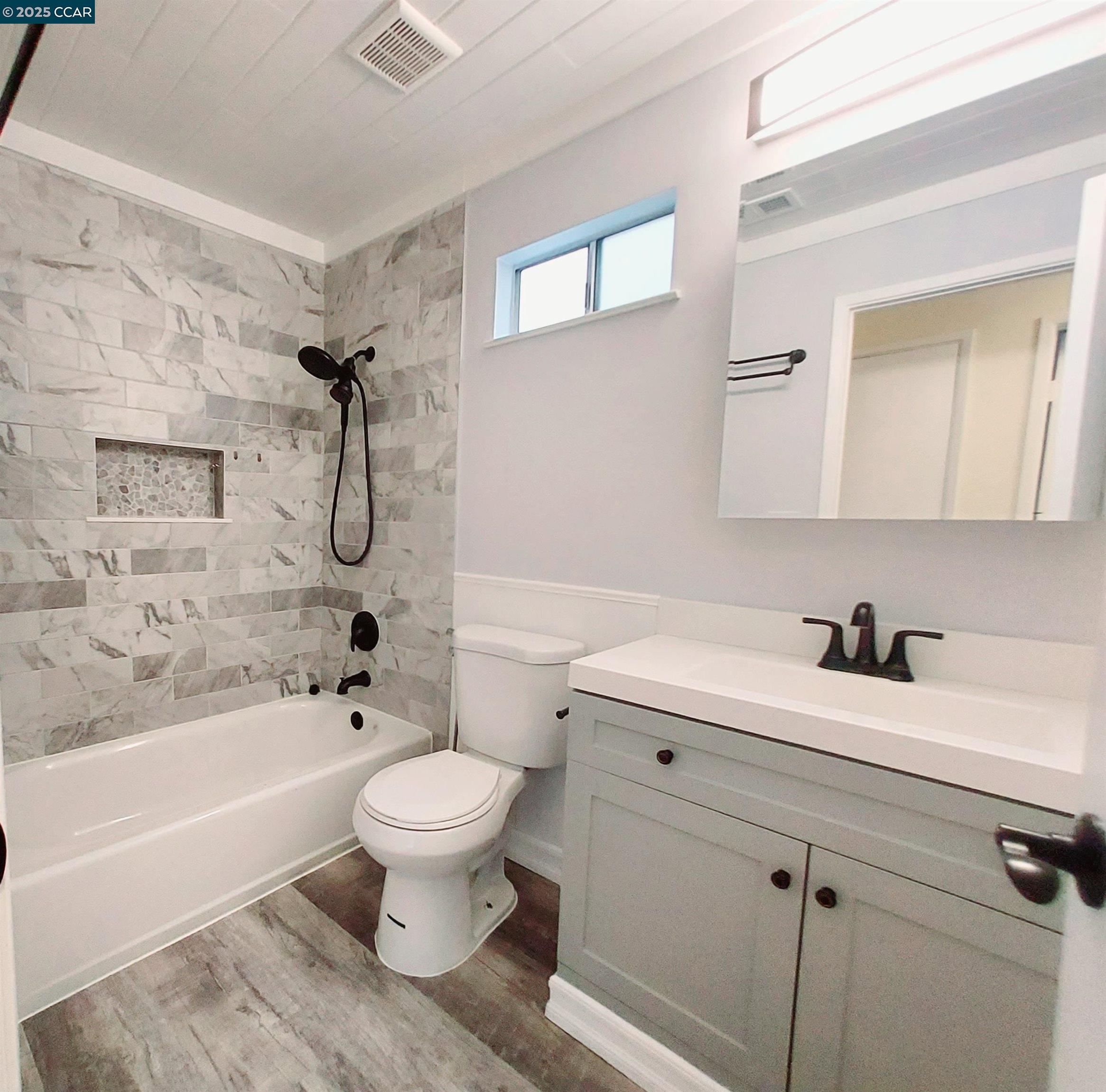 3712 Willow Pass Road, Unit 32 Concord, CA 94519 - Photo 19 of 20 a bathroom with a sink a toilet and a bathtub