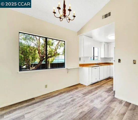 a view of kitchen with wooden floor and electronic appliances
