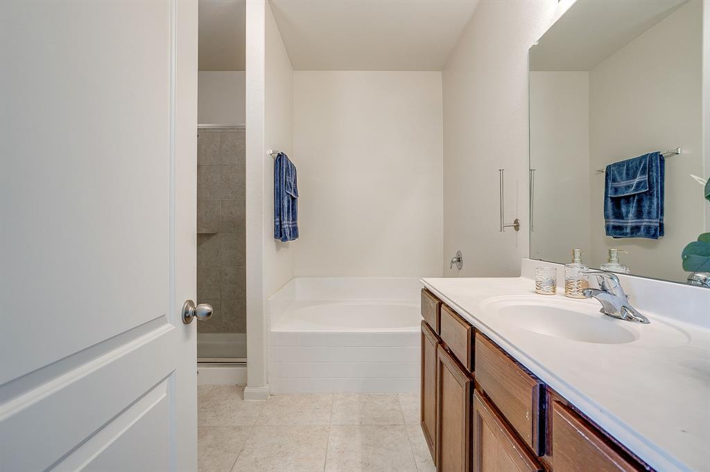 136 Kennedy Drive Venus, TX 76084 - Photo 12 of 27 a bathroom with a sink a tub and a mirror