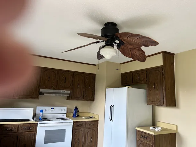 a kitchen with stainless steel appliances a refrigerator a stove a microwave and cabinets