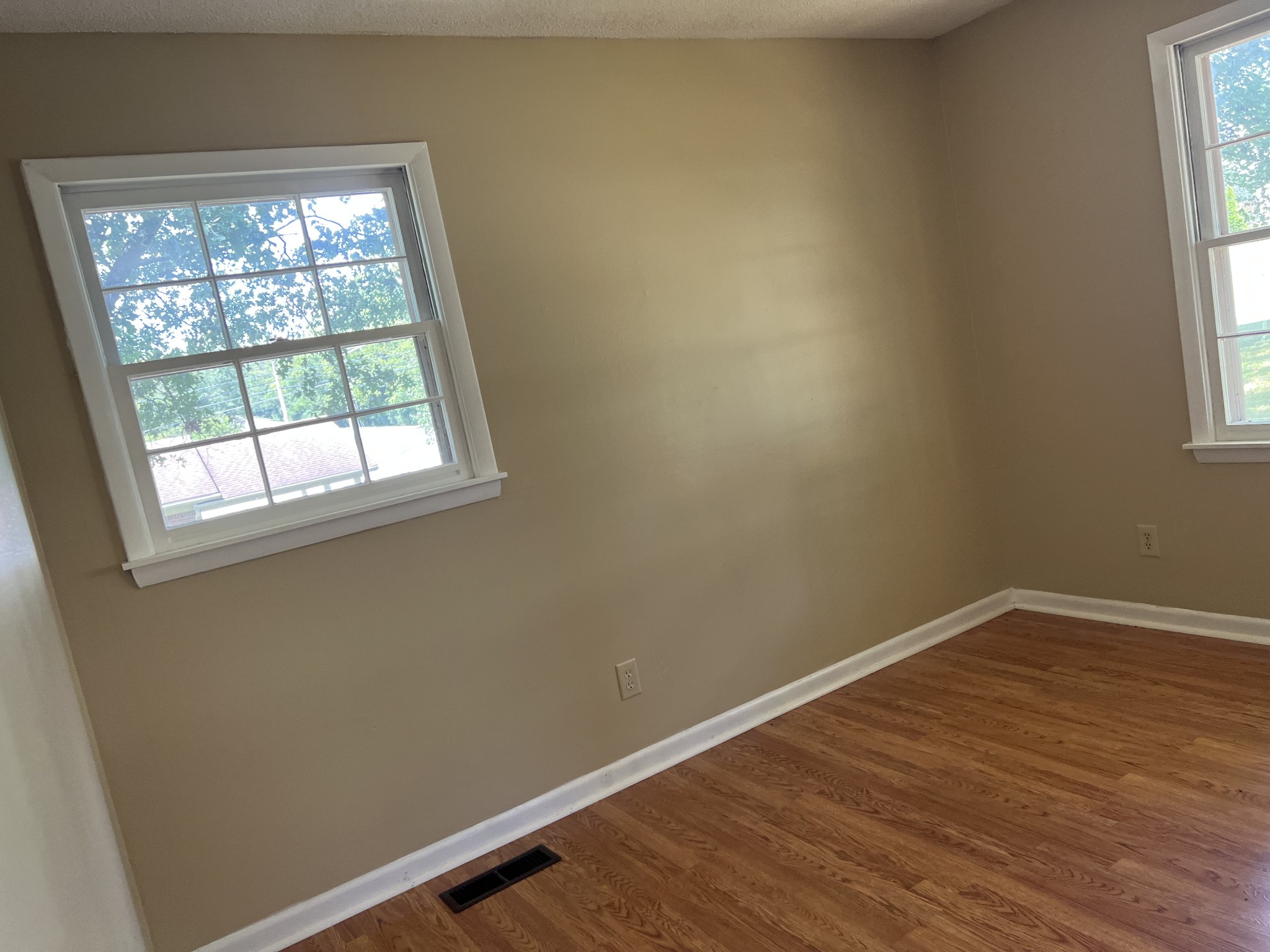 929 Industrial Access Road Pulaski, TN 38478 - Photo 23 of 28 an empty room with wooden floor and windows