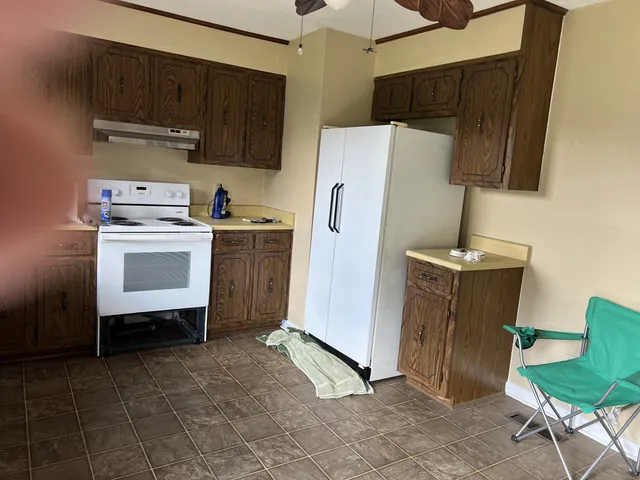 a kitchen with a refrigerator sink and cabinets