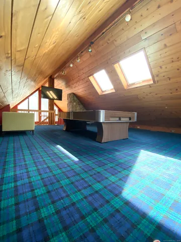 a room with hard wood floors and a wooden bench