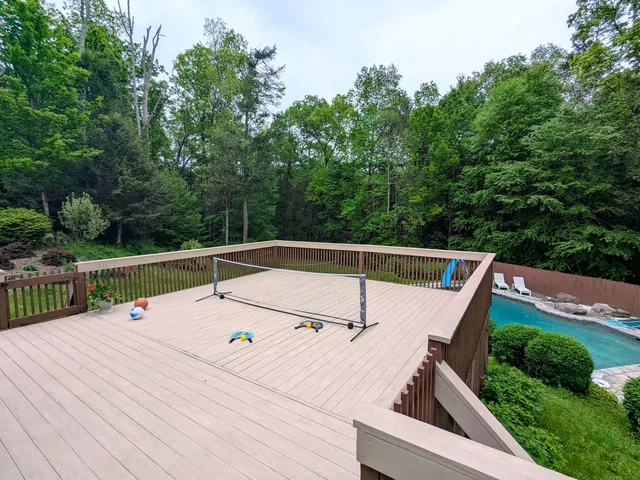 a view of deck with chairs and wooden fence