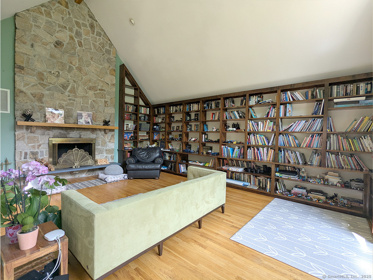 21 Holiday Point Road Sherman, CT 06784 - Photo 2 of 25 a living room with furniture a fireplace and potted plants