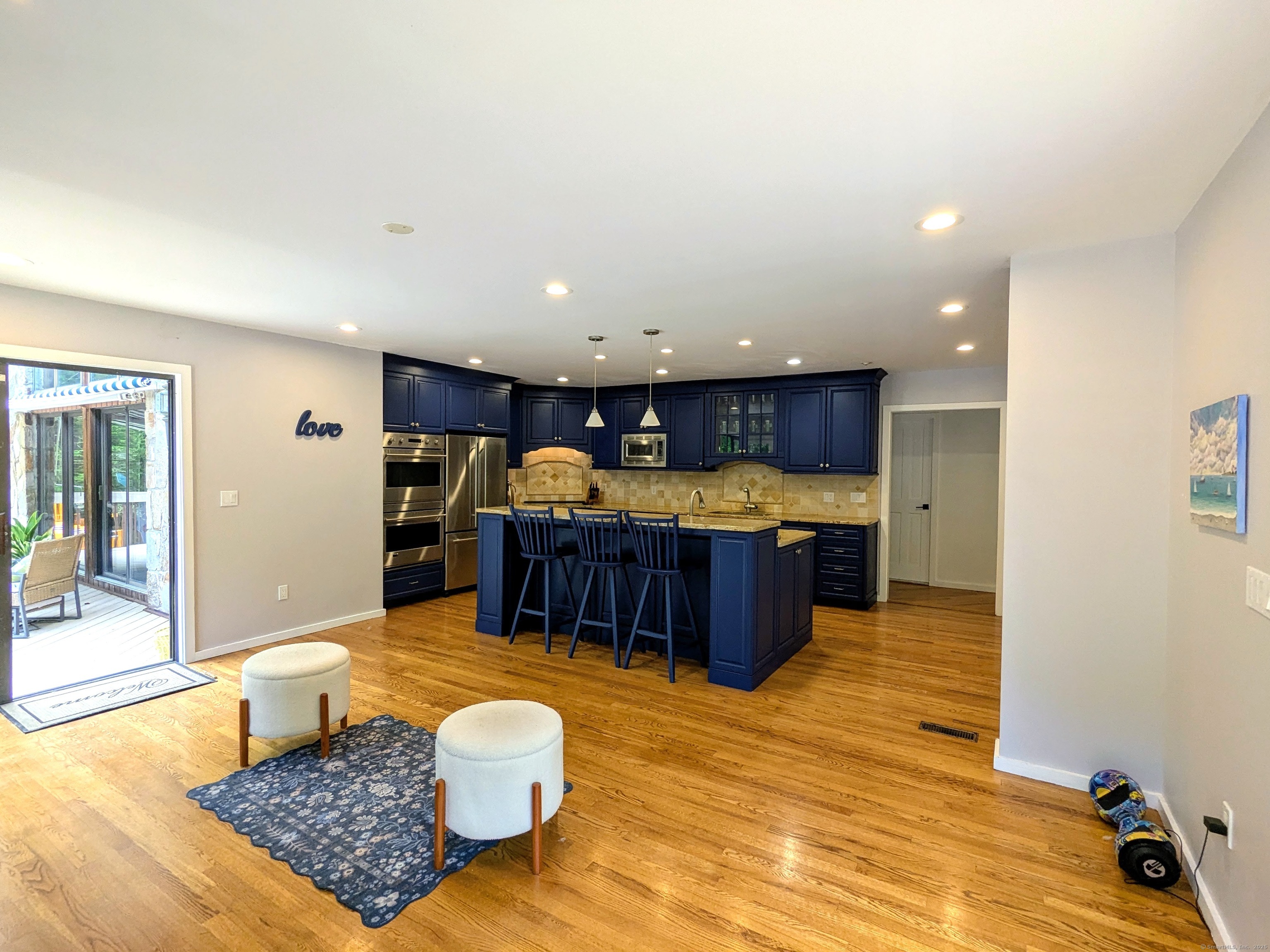 21 Holiday Point Road Sherman, CT 06784 - Photo 7 of 25 a living room with stainless steel appliances furniture a rug and a kitchen view