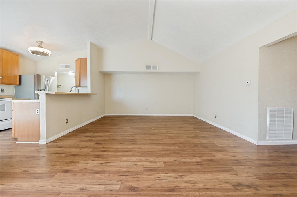 7305 Pineberry Road Dallas, TX 75249 - Photo 5 of 25 a view of a kitchen with wooden floor