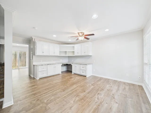 a view of a kitchen with kitchen island a sink stainless steel appliances and cabinets