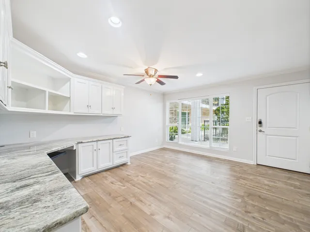 a view of a kitchen with wooden floor and a window