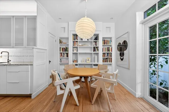 a dining room with furniture and wooden floor