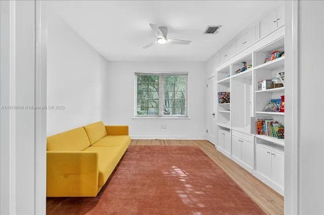 a living room with furniture and a book shelf