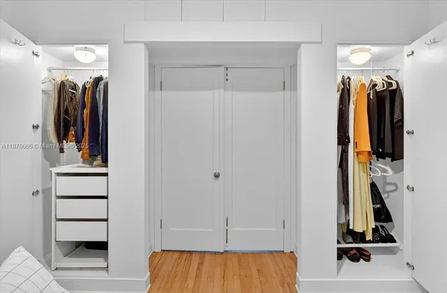 a view of walk in closet with clothes and shoes