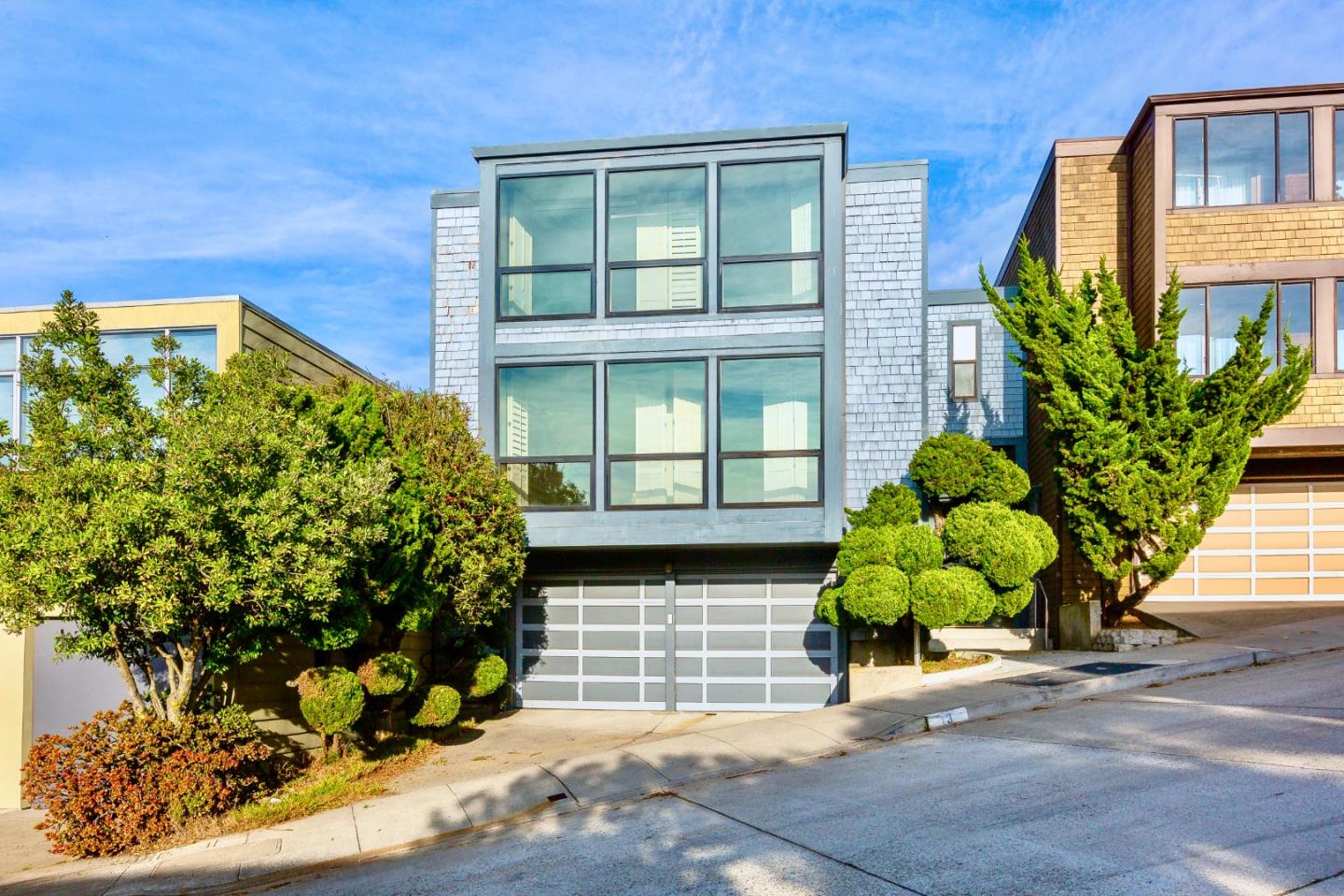 a house with a plant in front of it