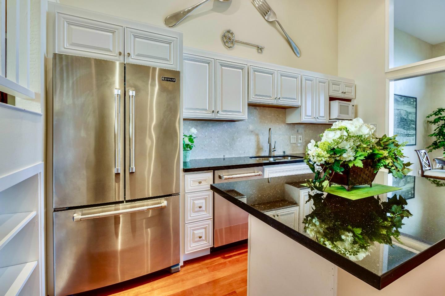 13 Ora Way San Francisco, CA 94131 - Photo 19 of 60 a kitchen with stainless steel appliances granite countertop a refrigerator a stove and a sink with wooden floor