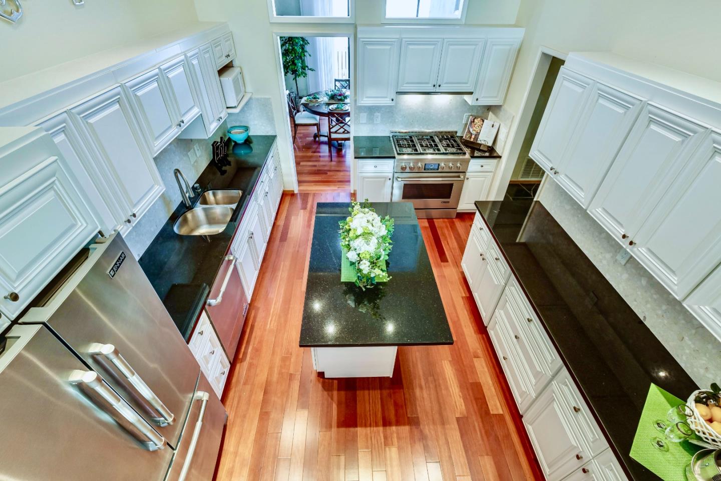 13 Ora Way San Francisco, CA 94131 - Photo 22 of 60 a kitchen with wooden floor white cabinets and stainless steel appliances