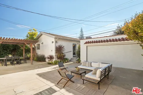 a view of a patio with table and chairs and potted plants
