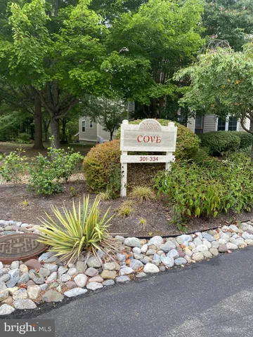 a front view of a house with a yard and garden