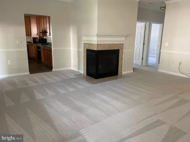 a view of empty room with kitchen fireplace and sink