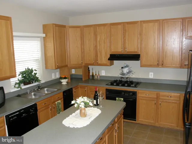 a kitchen with a sink stove and microwave