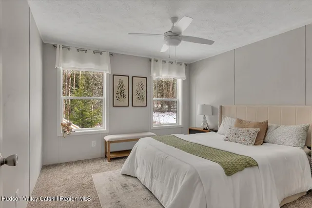 a bedroom with a large bed and a window