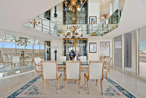 a view of a dining room with furniture and a chandelier
