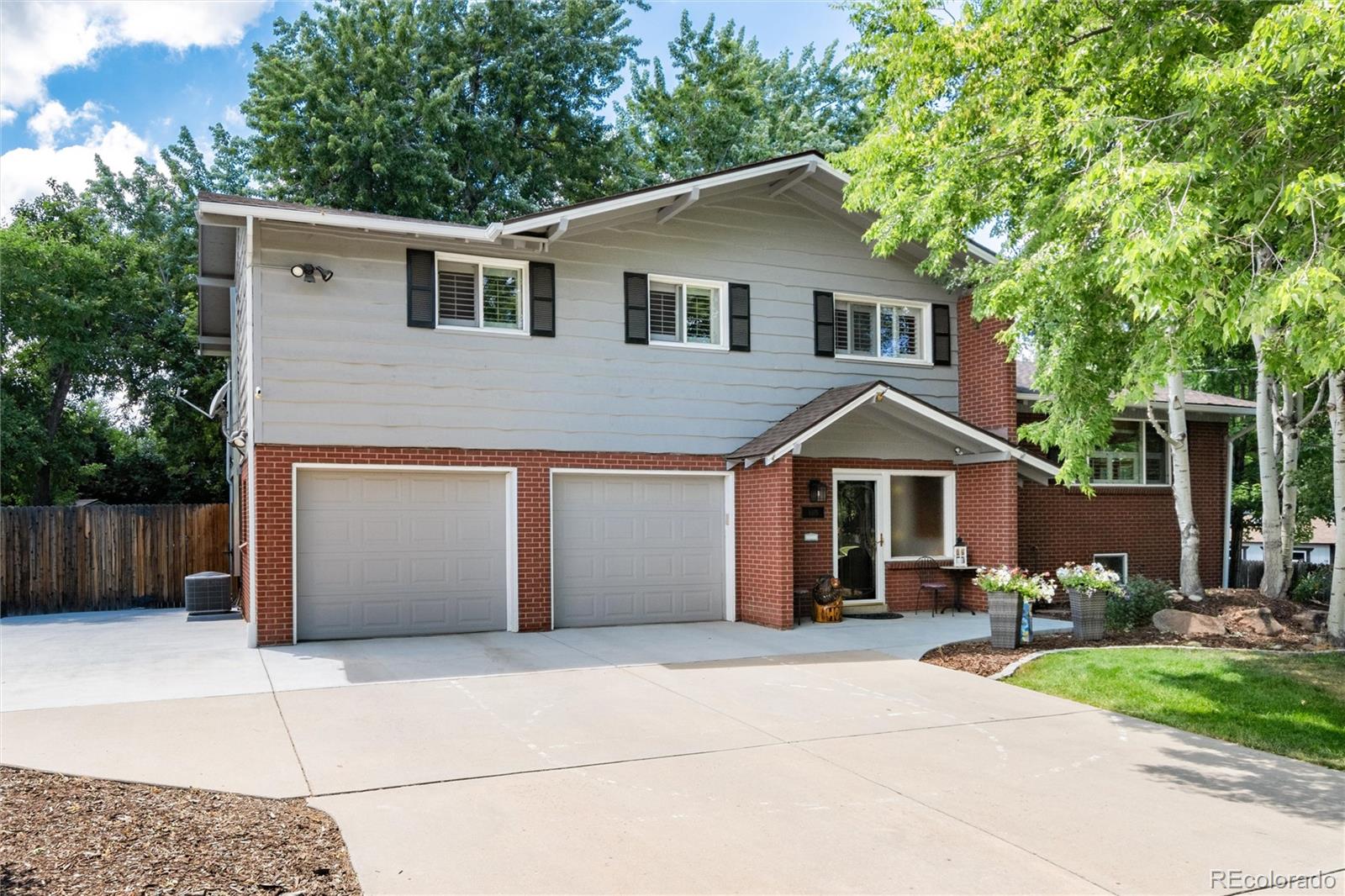 3375 Nelson Street Wheat Ridge, CO 80033 - Photo 1 of 35 a front view of a house with a yard and garage