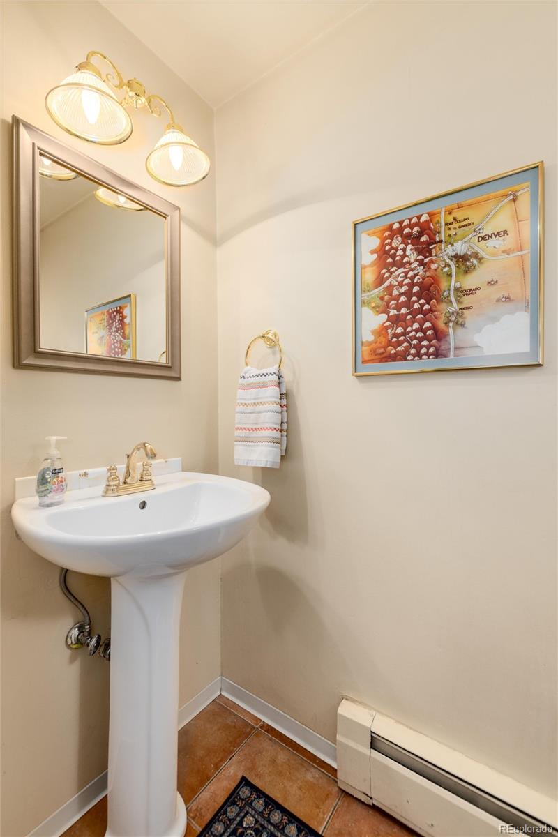 3375 Nelson Street Wheat Ridge, CO 80033 - Photo 16 of 35 a bathroom with a sink a mirror and a toilet