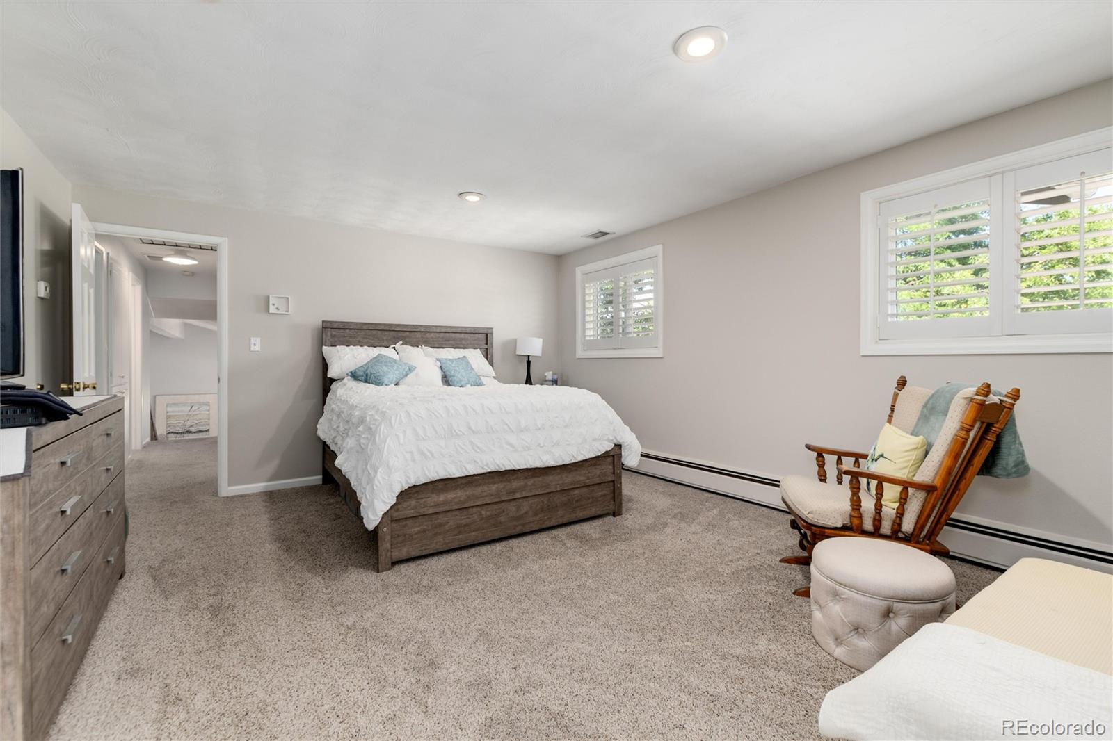 3375 Nelson Street Wheat Ridge, CO 80033 - Photo 17 of 35 a spacious bedroom with a bed and a couch
