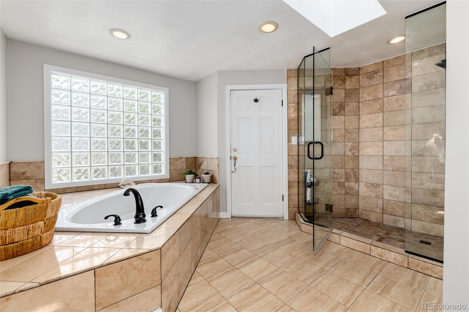 3375 Nelson Street Wheat Ridge, CO 80033 - Photo 19 of 35 a bathroom with a tub a sink and a shower