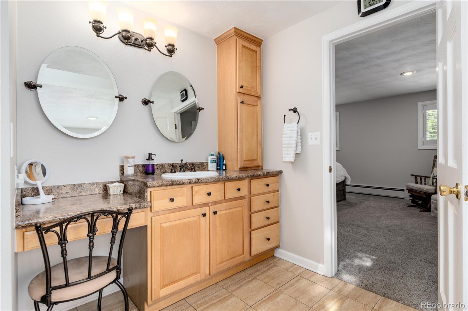 3375 Nelson Street Wheat Ridge, CO 80033 - Photo 20 of 35 a bathroom with a sink mirror and vanity