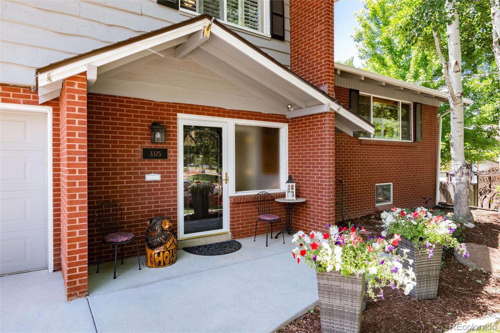 3375 Nelson Street Wheat Ridge, CO 80033 - Photo 2 of 35 a front view of a house with a patio