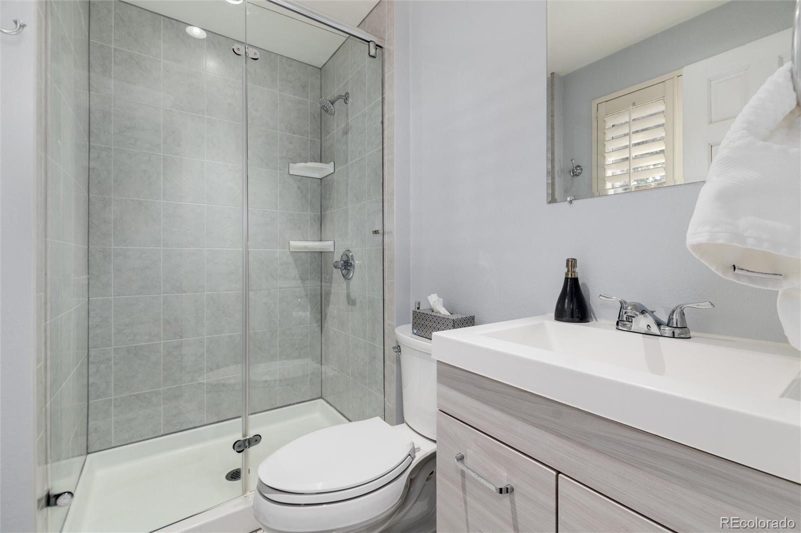 3375 Nelson Street Wheat Ridge, CO 80033 - Photo 22 of 35 a bathroom with a sink a toilet and shower