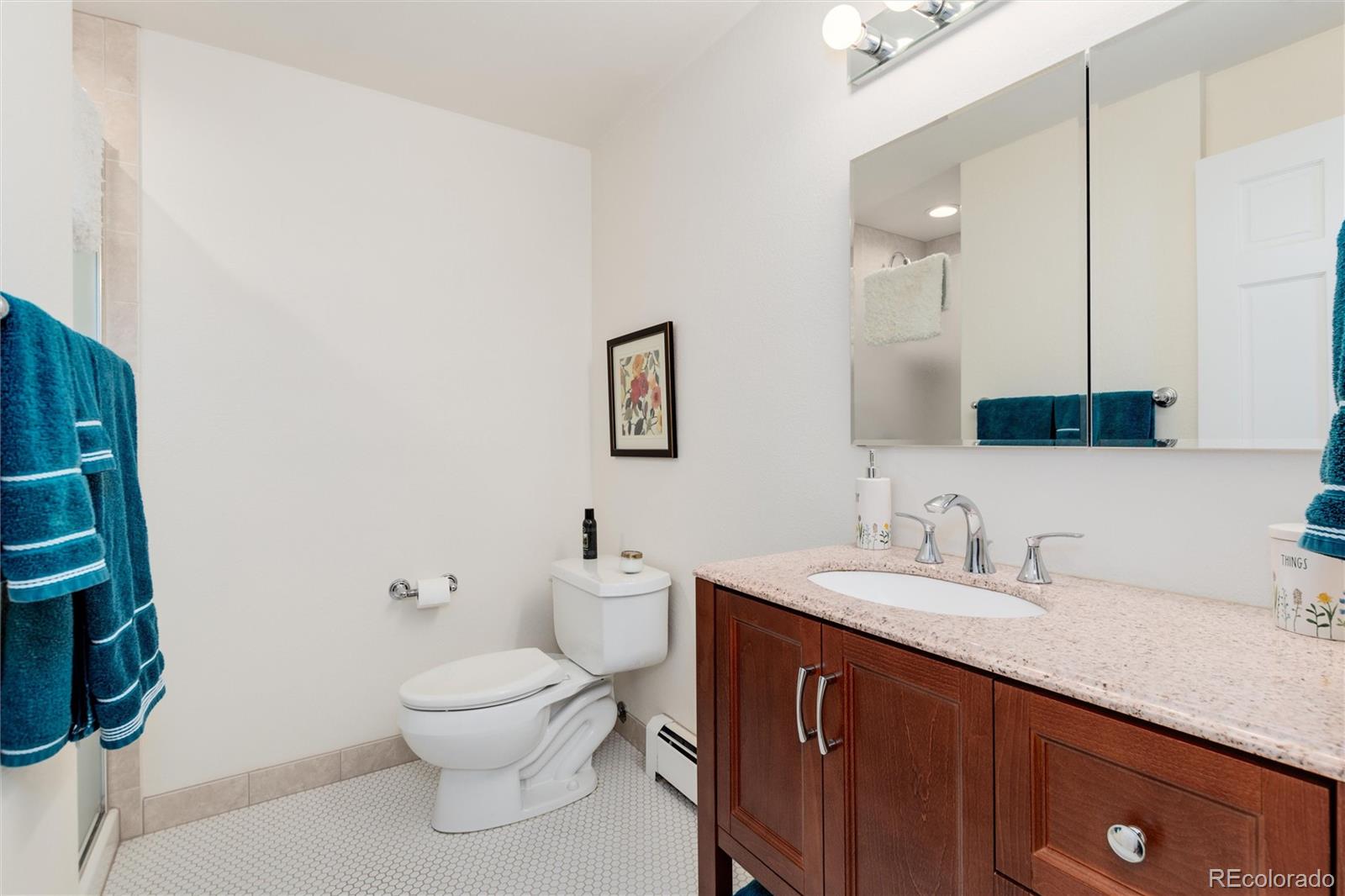 3375 Nelson Street Wheat Ridge, CO 80033 - Photo 24 of 35 a bathroom with a toilet a sink and mirror