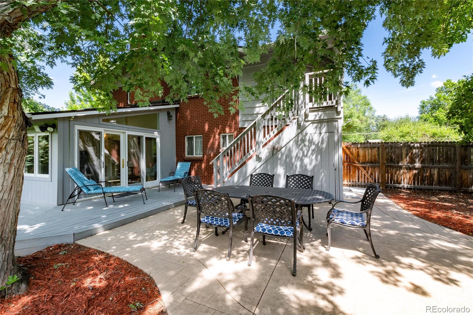 3375 Nelson Street Wheat Ridge, CO 80033 - Photo 26 of 35 a view of a patio with table and chairs with wooden floor and fence