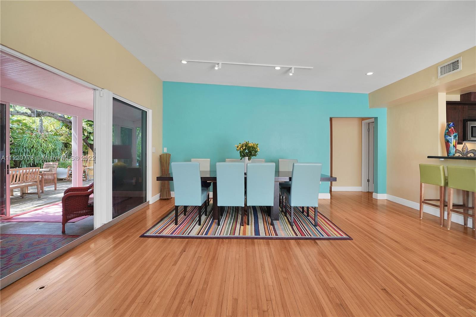 1810 Alamanda Drive North Miami, FL 33181 - Photo 14 of 40 a living room with a patio table and wooden floor