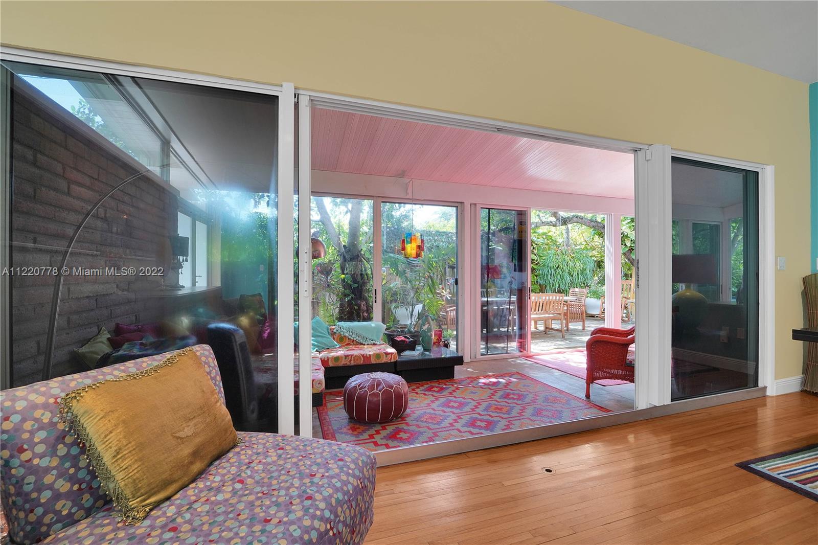 1810 Alamanda Drive North Miami, FL 33181 - Photo 16 of 40 a bedroom with furniture and a large window