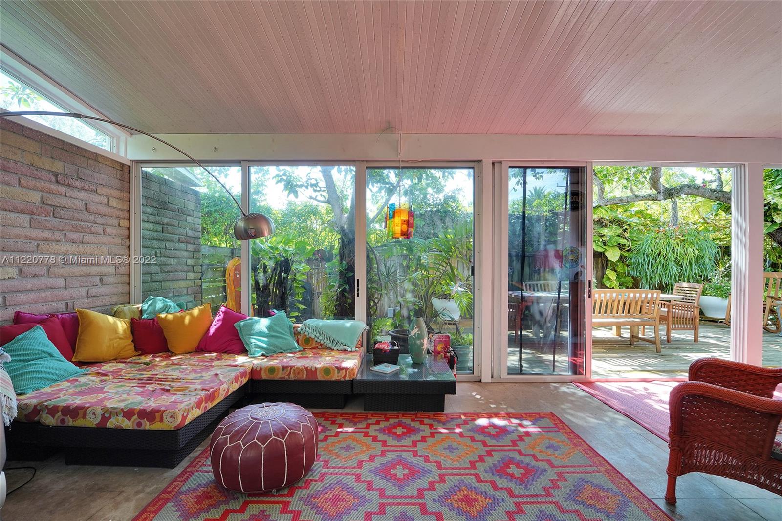 1810 Alamanda Drive North Miami, FL 33181 - Photo 17 of 40 a living room with furniture and a floor to ceiling window