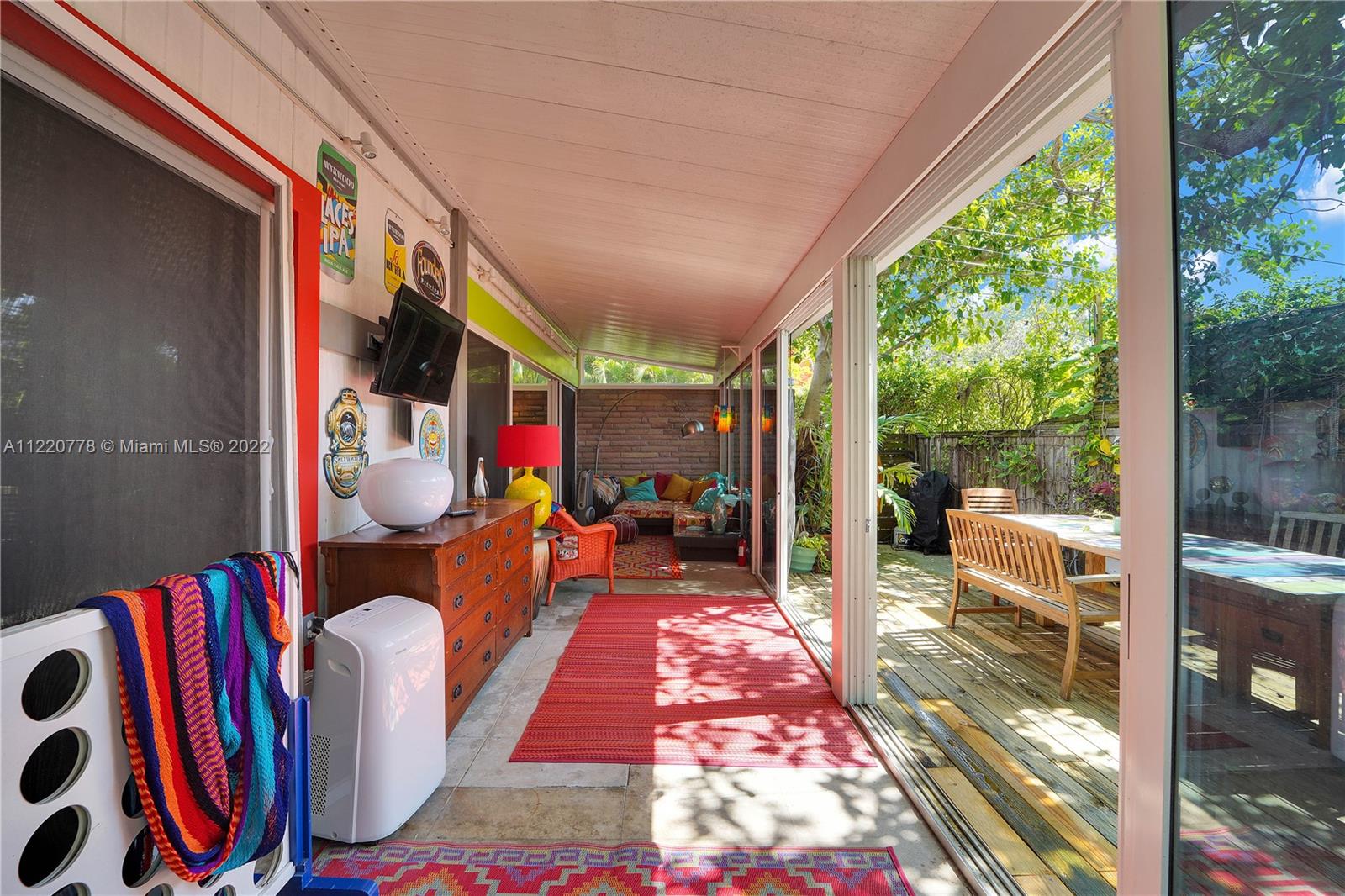 1810 Alamanda Drive North Miami, FL 33181 - Photo 20 of 40 a outdoor living space with patio furniture and a potted plant