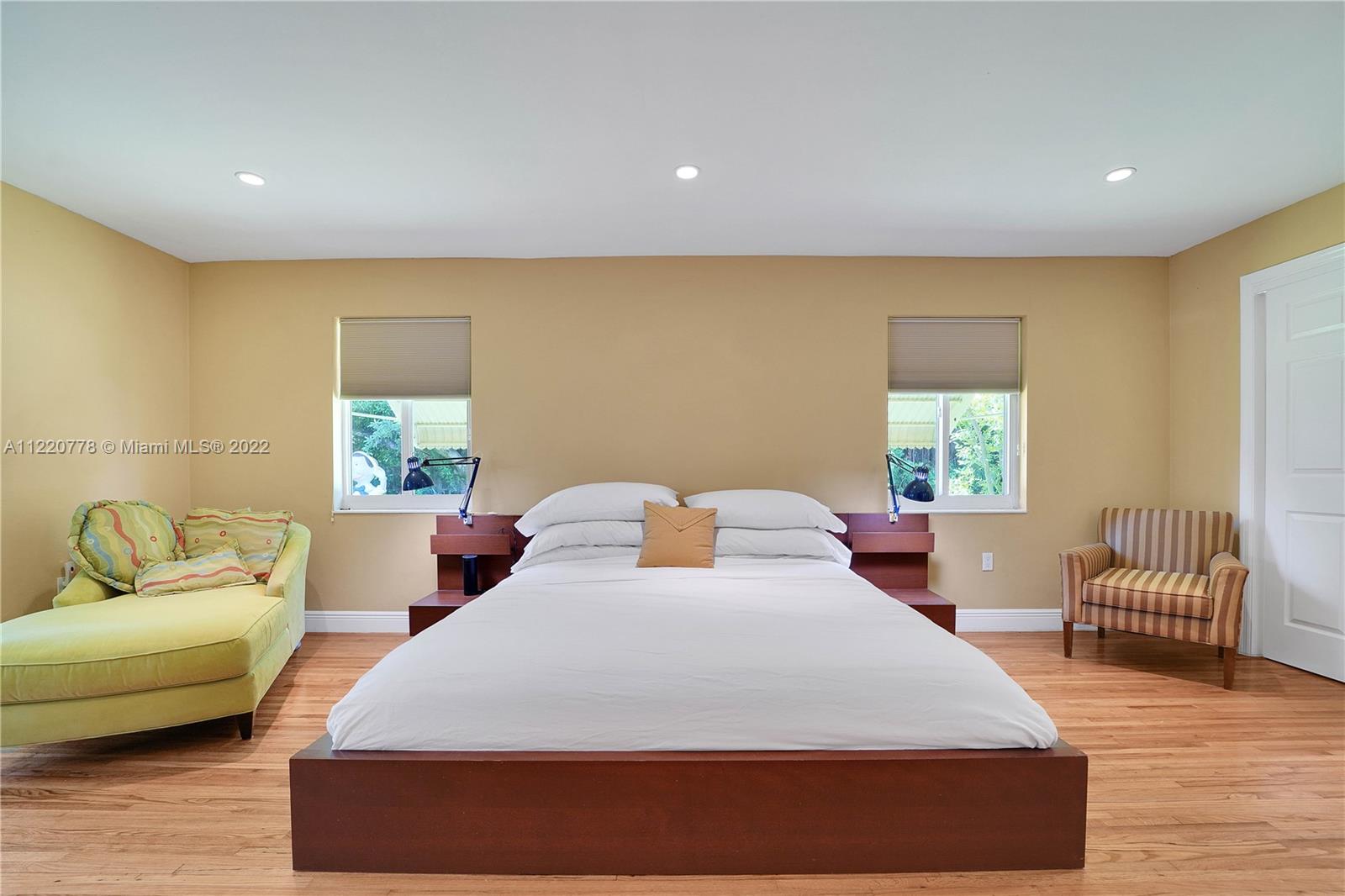 1810 Alamanda Drive North Miami, FL 33181 - Photo 26 of 40 a bedroom with a bed and wooden floor