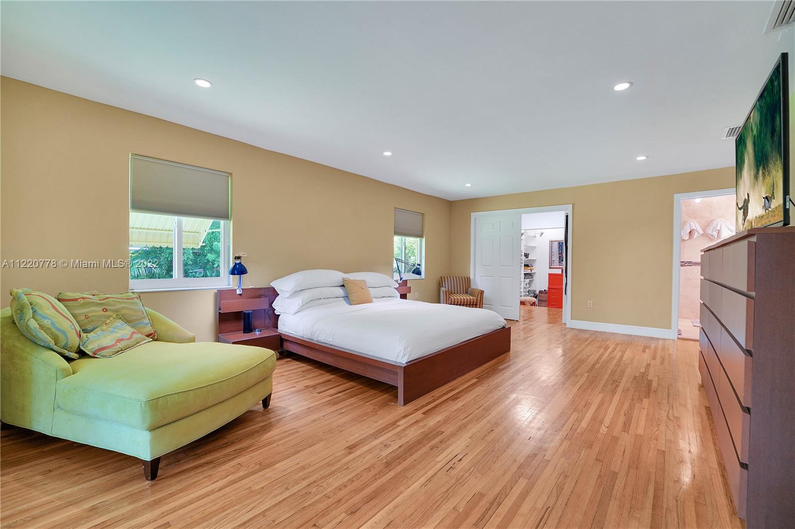 1810 Alamanda Drive North Miami, FL 33181 - Photo 27 of 40 a bedroom with a bed window and wooden floor