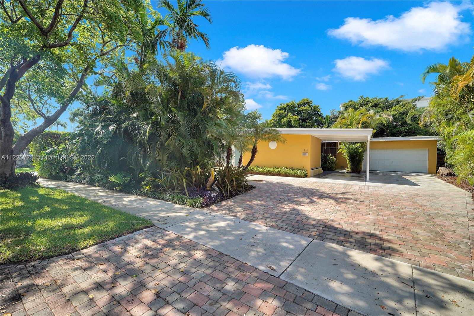1810 Alamanda Drive North Miami, FL 33181 - Photo 3 of 40 a view of a house with backyard and a tree